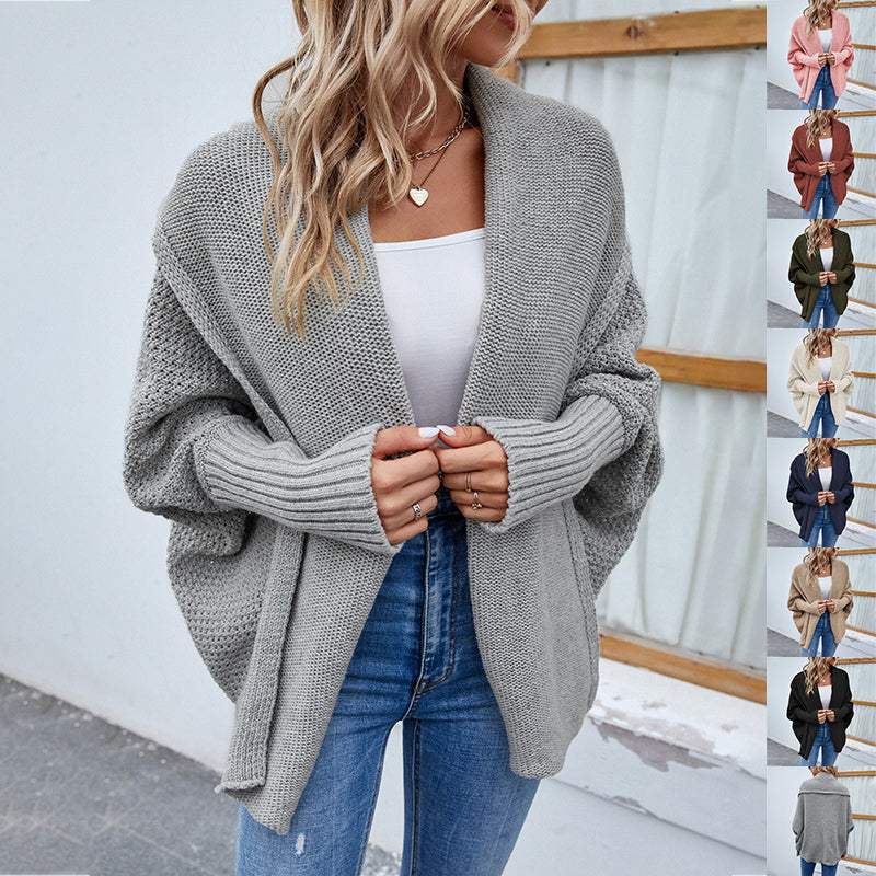 Women wearing loose knitted sweater with bat sleeve and large lapel cardigan in solid color autumn winter jacket
