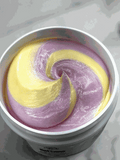 Bottle of Beltane Body Cream with oakmoss and floral scent on wooden surface