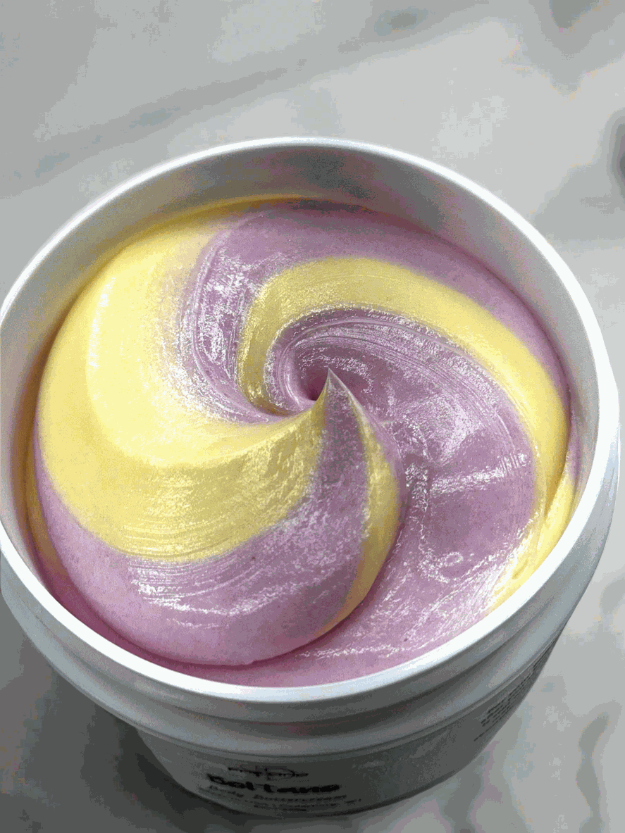 Bottle of Beltane Body Cream with oakmoss and floral scent on wooden surface