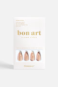 Set of medium stiletto nude press-on nails with soft neutral tones and angled accent